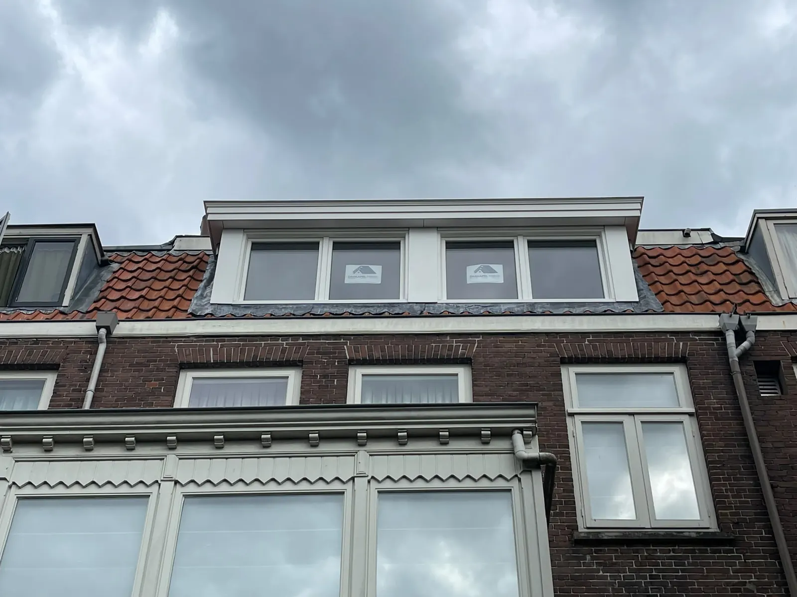 Witte dakkapellen op een rij herenhuizen